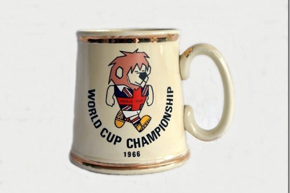 World Cup Willie 1966 Ceramic Tankard: Rare China tankard made by Gibson + Sons of Stoke featuring on one side World Cup Willie with World Cup Championship and official logo the other. Stunning tankard has slight wear on gold rim. Very Good original 50 year old with no repairs or previous damage.